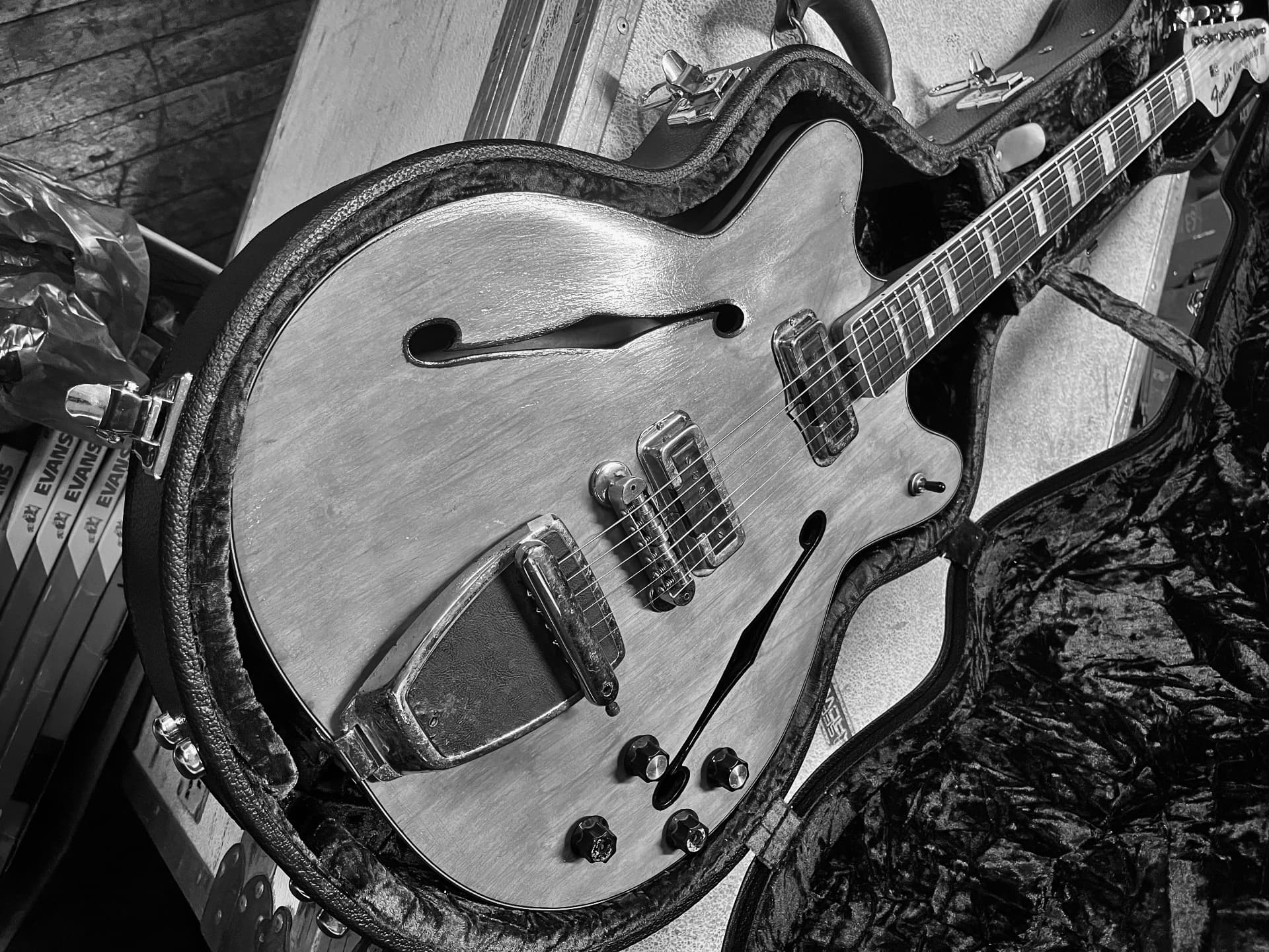 Vintage hollow-body electric guitar resting in its open case